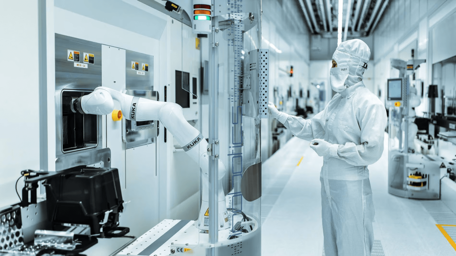 Semiconductor cleanroom technician operating advanced fabrication equipment